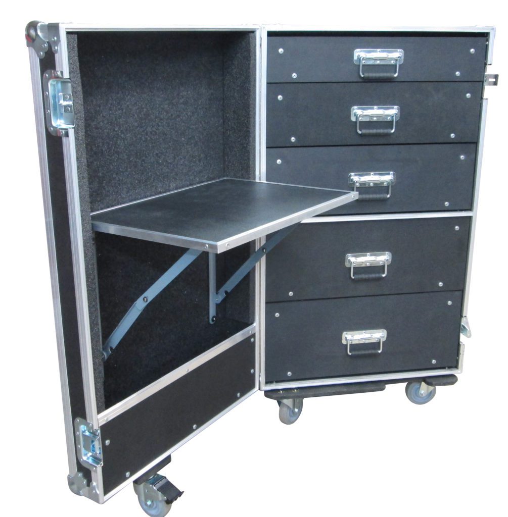 Against a white backdrop, we see a standing, opened, black road case with a pull-out tabletop surface and multiple drawers.